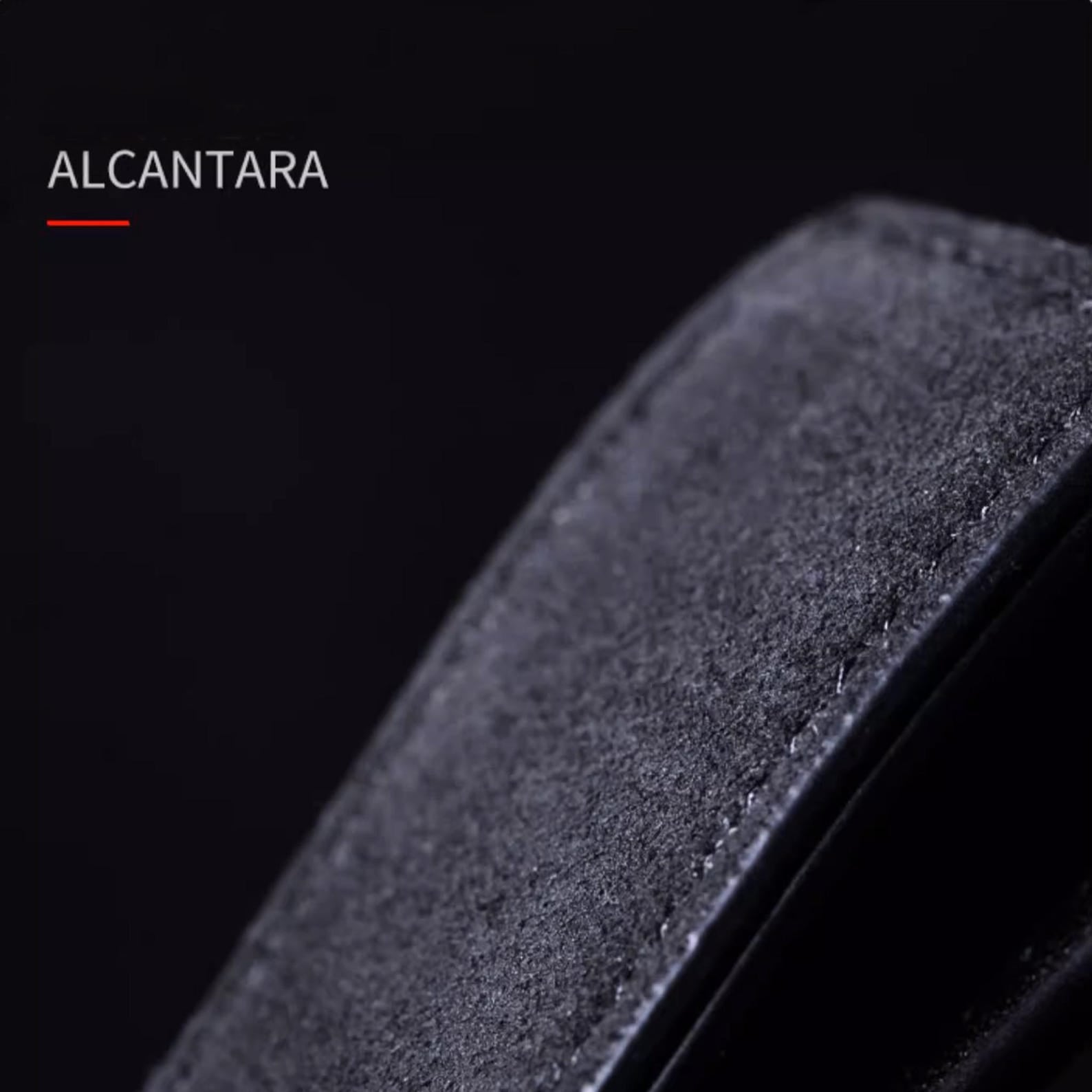 Luxury Alcantara leather car logo keychain on a wooden surface